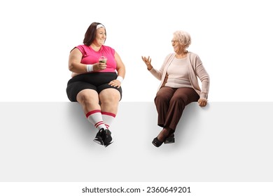 Elderly woman sitting on a panel and talking to an overweight woman holding a healthy green smoothie isolated on white background - Powered by Shutterstock