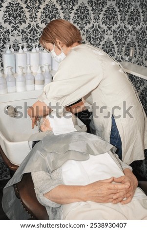 Similar – Image, Stock Photo Caregiver helping elderly female patient to get out of bed