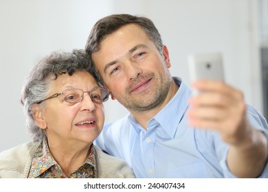 Elderly Woman With Son Making Selfy Picture With Smartphone