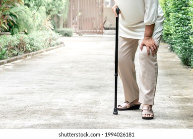 Elderly Woman Standing On The Street She Is Having Symptoms Pain On Both Sides Of The Knee, Due To Osteoporosis, To Retirement Age And Health Care Concept.