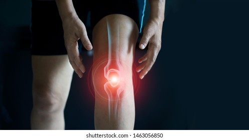 Elderly woman suffering from pain in knee. Tendon problems and Joint inflammation on dark background.