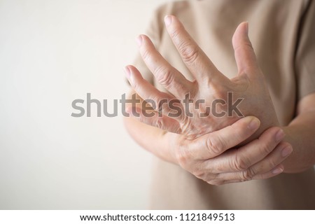 Elderly woman suffering from pain, numbness or weakness in hands. Causes of hurt include osteoarthritis, rheumatoid arthritis, gout, peripheral neuropathy, lupus or Raynaud’s phenomenon. Health care. 