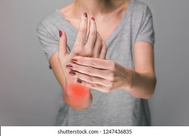 Elderly woman suffering from pain, weakness and tingling in wrist. Causes of hurt include osteoarthritis, rheumatoid arthritis, gout or wrist sprain. Health care