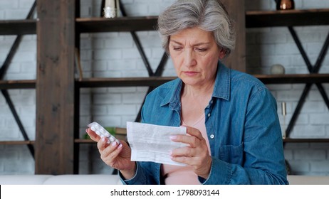 An Elderly Woman With Tablets In Her Hands And Reads A Prescription Medication.