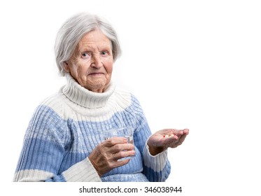 Elderly Woman Taking Her Medication Over White 