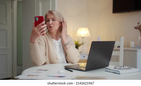 Elderly Woman Talking To Family Via Video Call Using Phone