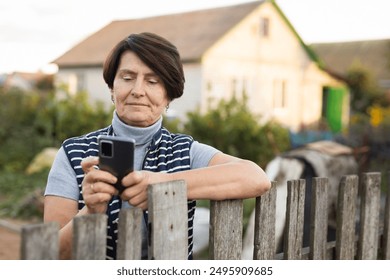 Elderly woman talking on mobile phone near - Powered by Shutterstock