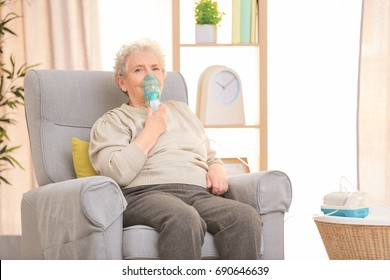 Elderly Woman Using Asthma Machine At Home