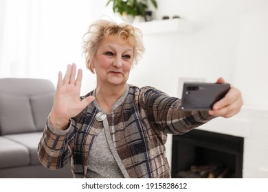 Elderly Woman Using Touch Screen Mobile For Taking Selfie Or Making Video Call