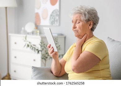 Elderly Woman Video Chatting With Doctor At Home