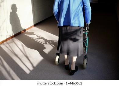 Elderly Woman With Walker In A Hallway, Black And White