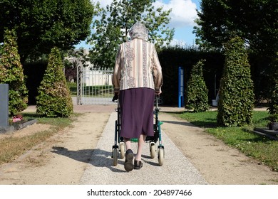 Elderly Woman With Walker, Visiting Cemetery