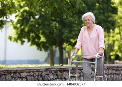 Elderly Woman With Walking Frame Outdoors. Medical Help