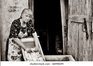 Elderly woman with washboard.