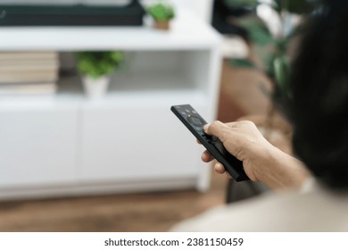 Elderly woman Watching smart TV and using remote controller Hand holding television audio remote control Middle age Asian woman movie Television series spending time at home. - Powered by Shutterstock