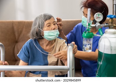 Elderly Woman Wearing Oxygen Nasal Cannula At Home.