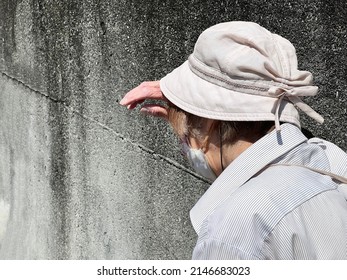 Elderly Woman Wiping Sweat On Her Forehead