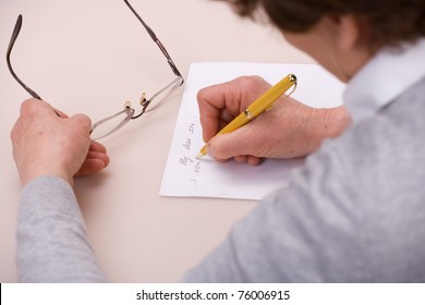 elderly woman writing letter