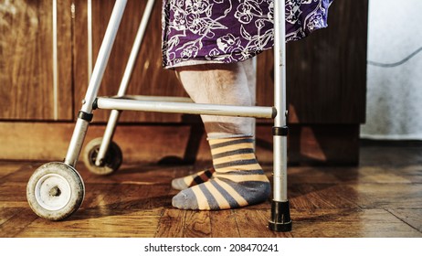 Elderly Womans Feet Making Slow Steps With The Aid Of Walker