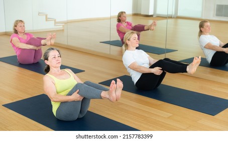 Elderly Women Maintaining Mental And Physical Health Attending Yoga Class At Studio, Practicing Balancing Poses