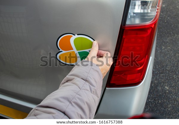 Elderly women\
pasting the elderly driving\
mark.
