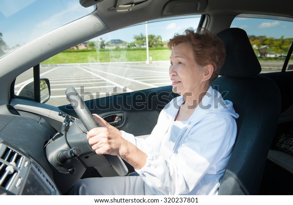 Elderly women who are driving\
a car
