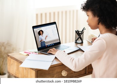 E-Learning Concept. African Schoolgirl At Laptop Having Online Class With Teacher Learning At Home. Selective Focus