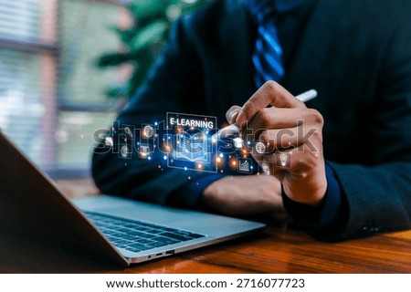 E-learning concept, Business professional using e-learning digital interface on laptop with stylus pen, knowledge sharing, corporate learning, technology innovation, training digital online