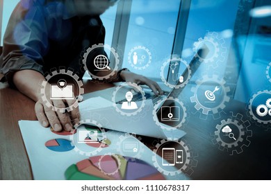 E-learning with connected gear cogs connected diagram virtual dashboard.business documents on office table with smart phone and digital tablet and graph business diagram and man working.