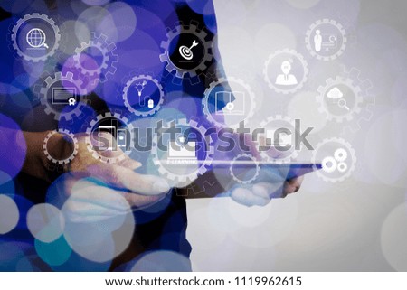 E-learning with connected gear cogs connected diagram virtual dashboard.Double exposure of businessman hand using Tablet computer with colour cloud concept.