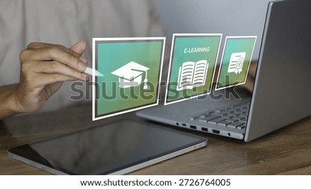 E-learning and digital education system concept shown through a close-up of a person using a stylus pen on a tablet alongside a laptop. The image features high-quality holographic icons floating in the air, including a graduation cap, an open book with the "E-LEARNING" label, and a certified diploma. This visual represents the modern shift toward virtual classrooms, online certification, distance learning, and the use of artificial intelligence in education. It is an ideal representation for EdTech marketing, remote studying, and global academic accessibility