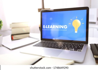 E-learning Education Internet Networking . Young businesswoman sitting and used laptop with inscription on screen e-learning. Online education e-learning.