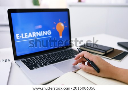 E-learning Education Internet Networking . Young businesswoman sitting and used laptop with inscription on screen e-learning. Online education e-learning.