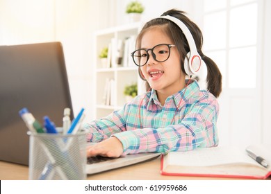 e-learning give preschool kids perfect study resource. asia cute sweet children typing with computer keyboard and listen headsets.