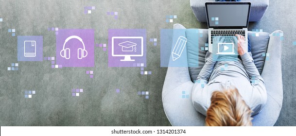E-Learning with man using a laptop in a modern gray chair - Shutterstock ID 1314201374