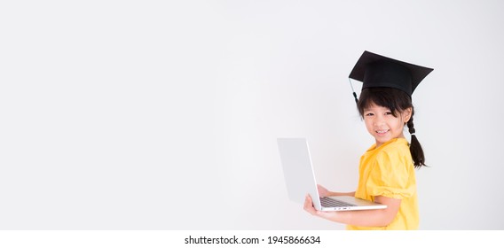 E-learning, Online Education At Home.Online Education.Distance Learning, Asian Kid Child School Girl Online Learning With Laptop.Smart Kid Wearing Graduate Cap.Success, Programing, Homeschool Student.