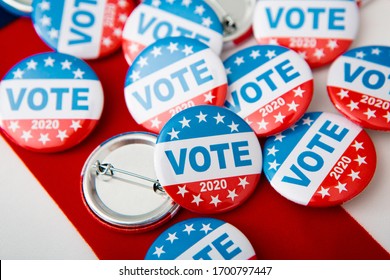 Election 2020 in the USA. Variety Of Presidential Election Buttons on American flag