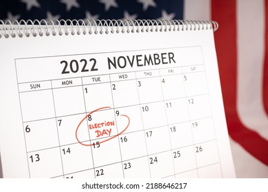 Election day concept. Desk calendar with November 8 2022 marked in red and USA flag at background - Shutterstock ID 2188646217