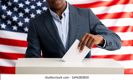Election in USA. Voter pulls vote ballot. USA flag on background. Democracy concept, panorama