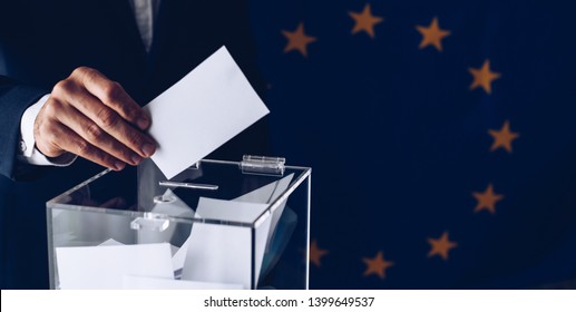 Elections To The European Parliament. EU Elections. Man Throwing His Vote Into The Ballot Box.