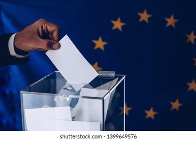 Elections To The European Parliament. EU Elections. Man Throwing His Vote Into The Ballot Box.