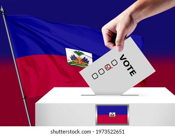Elections in the Haiti. The hand that puts the game in the ballot box. Haiti flags in the background. Country flag election.