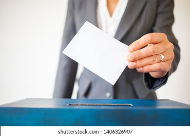 Elections, The Hand Of Woman Putting Her Vote In The Ballot Box