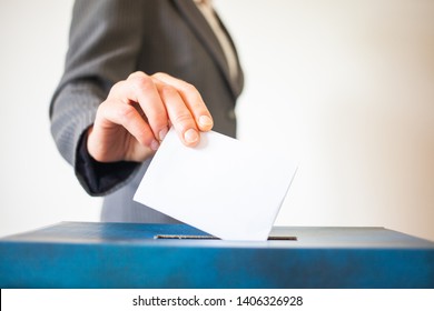 Elections, The Hand Of Woman Putting Her Vote In The Ballot Box