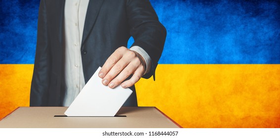 Elections In Ukraine, Political Struggle. Democracy, Freedom And Independence Concept.
Man Voter Putting Ballot In To Voting Box