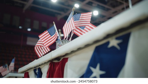 Elections in the United States of America. Close up of table for voting registration with American flags standing at polling place. Presidential race and election coverage. Civic duty and patriotism. - Powered by Shutterstock