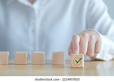 Elections And Voting, Vote, To Do List, Checklist, Task List, Survey And Assessment Concept. Hand Pick Green Check Mark On Wooden Block.