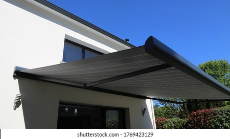 electric aluminum modern awning on  a modern house