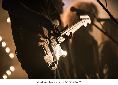 Electric Bass Guitar Player On The Stage With Strobe Illumination, Live Hard Rock Music Theme