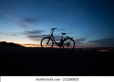 Electric Bicycle In Sunset 